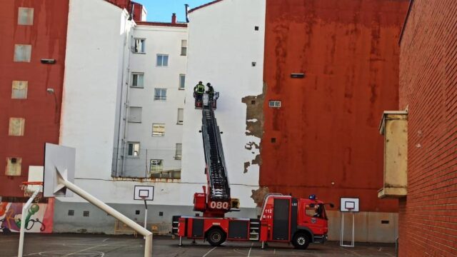 Los bomberos de León limpian la fachada de la que caen cascotes. Bomberos de León